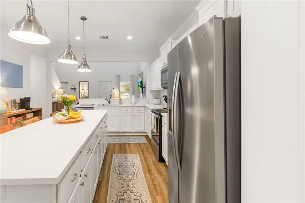 a kitchen with stainless steel appliances granite countertop a refrigerator and a sink