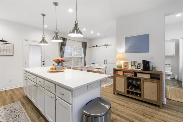 a kitchen with a sink a stove and a wooden floor