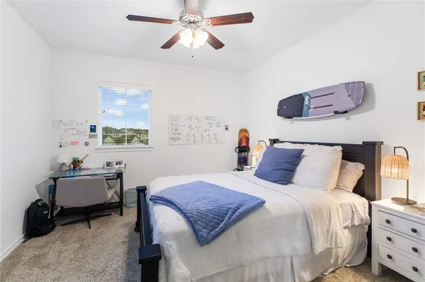 a bedroom with a bed and a desk