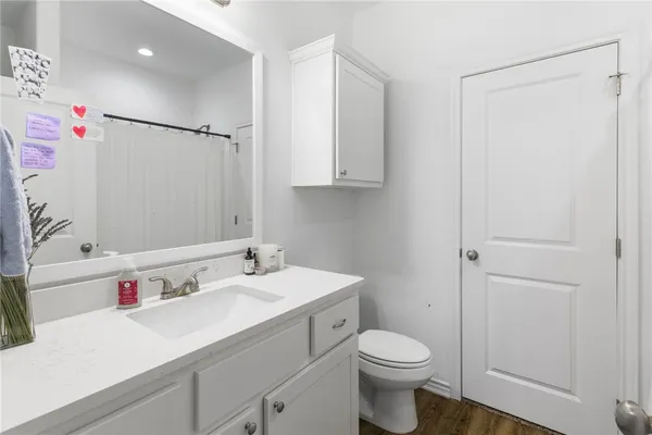 a bathroom with a sink toilet vanity and shower