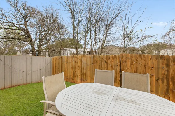 a view of a backyard with wooden fence