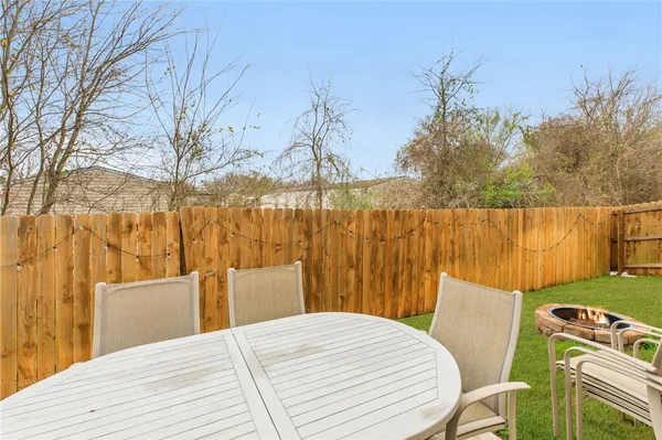 a view of a backyard with wooden fence