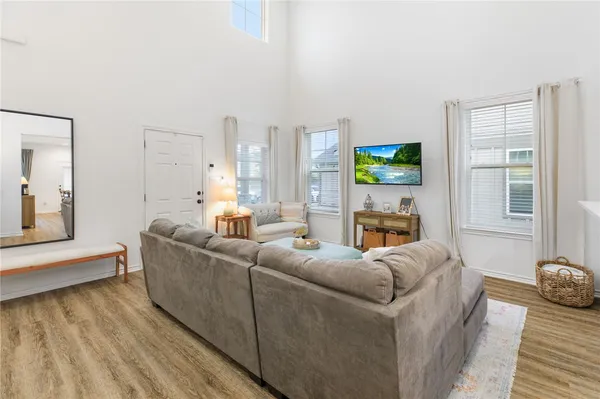 a living room with furniture a flat screen tv and a fireplace