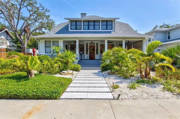 a front view of a house with a garden