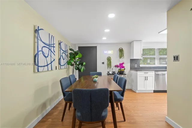 a dining room with furniture and wooden floor