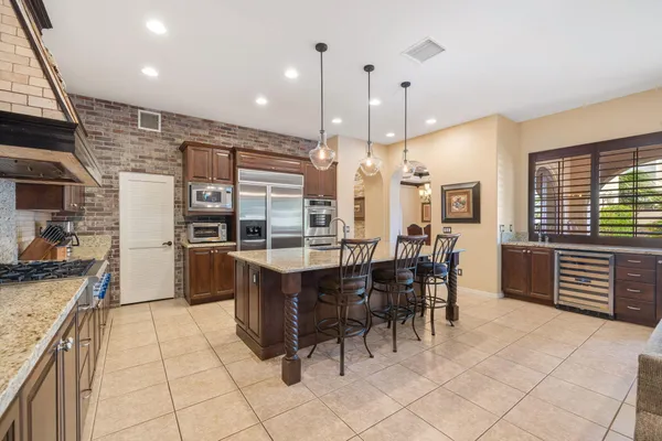 a kitchen with stainless steel appliances granite countertop a sink and a stove