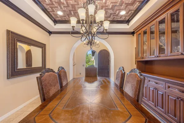 a bedroom with a large bed and a chandelier