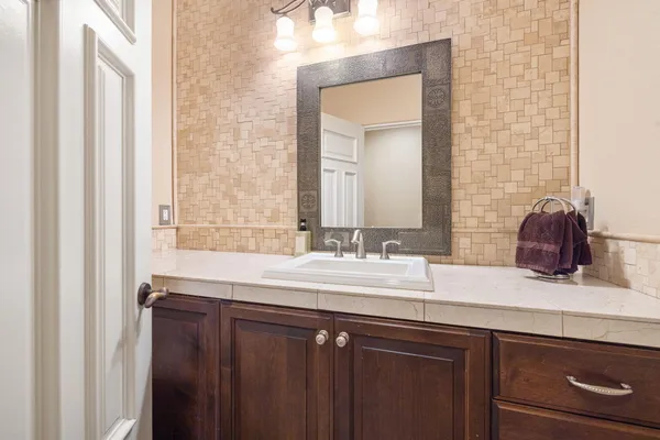 a bedroom with a large bed and a chandelier