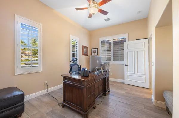 a spacious bedroom with a bed and a table in it
