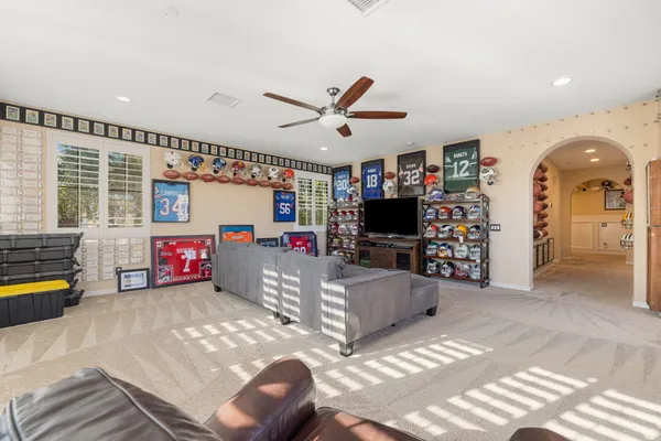 a view of a patio with couches table and chairs and potted plants