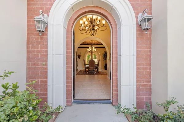 a large kitchen with kitchen island a large counter and chairs