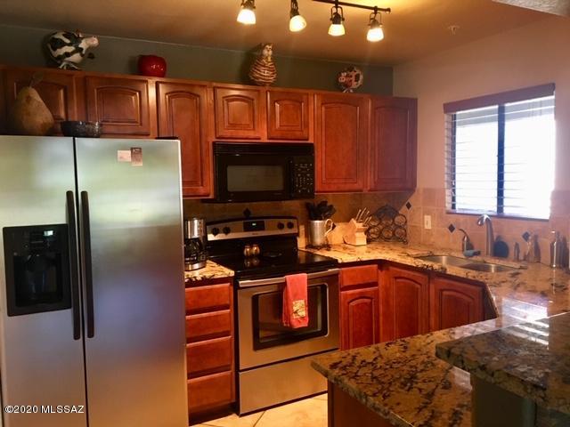5751 North Kolb Road, Unit 36203 Tucson, AZ 85750 - Photo 6 of 25 a kitchen with stainless steel appliances granite countertop a refrigerator and a sink