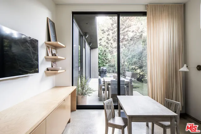 a kitchen with a table chairs and refrigerator