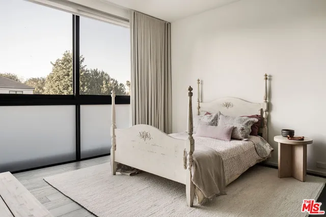 a bed room with a bed and a window