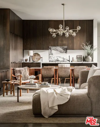 a living room with furniture and chandelier