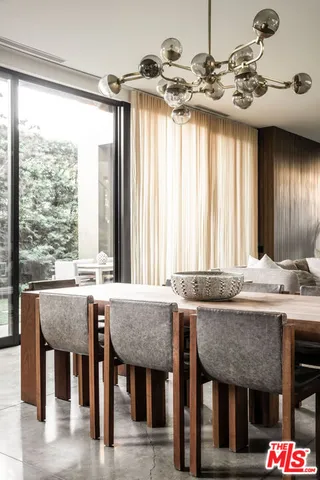 a dining table with chairs and window