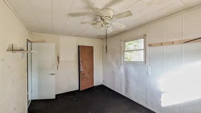 a view of a hallway with a chandelier fan