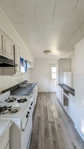 a kitchen with a sink appliances and cabinets