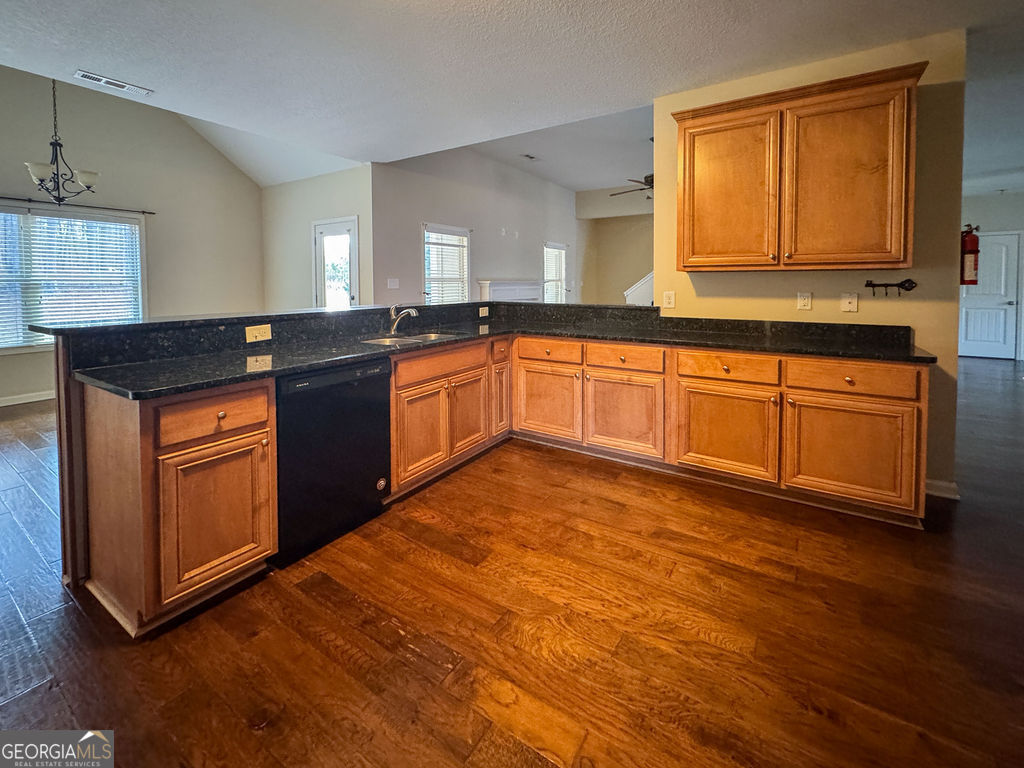 170 Fire Crk Trail Senoia, GA 30276 - Photo 17 of 62 a kitchen with stainless steel appliances granite countertop a stove a sink and a microwave