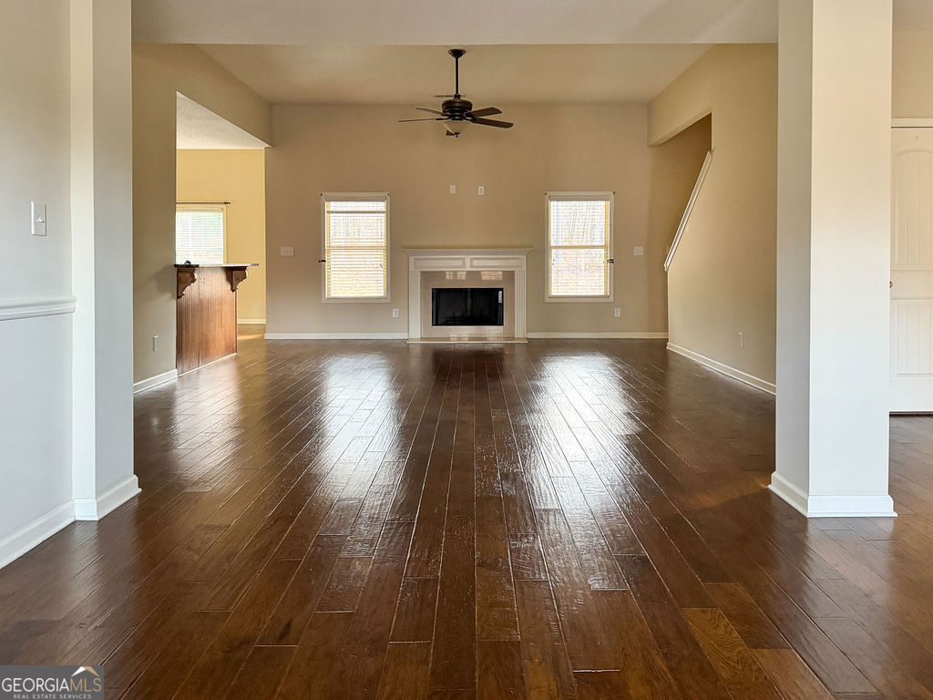 170 Fire Crk Trail Senoia, GA 30276 - Photo 5 of 62 wooden floor in an empty room with a fireplace
