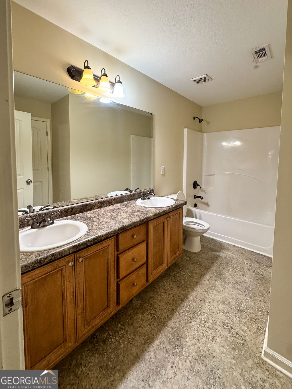 170 Fire Crk Trail Senoia, GA 30276 - Photo 54 of 62 a spacious bathroom with a sink mirror and a bathtub