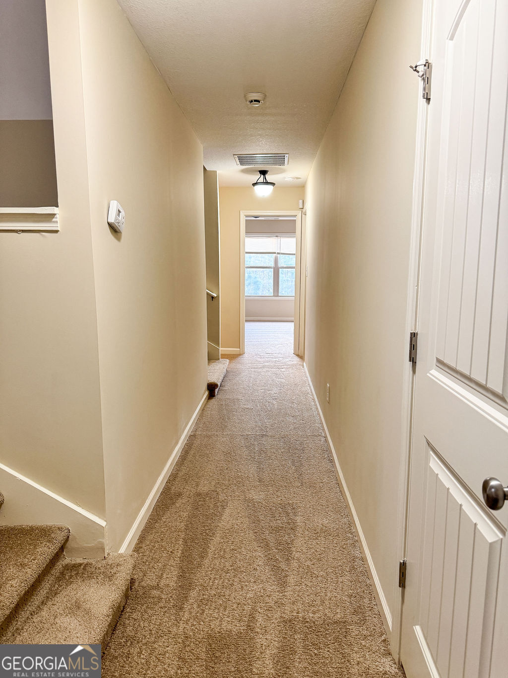 170 Fire Crk Trail Senoia, GA 30276 - Photo 55 of 62 a view of a hallway with wooden floor and staircase