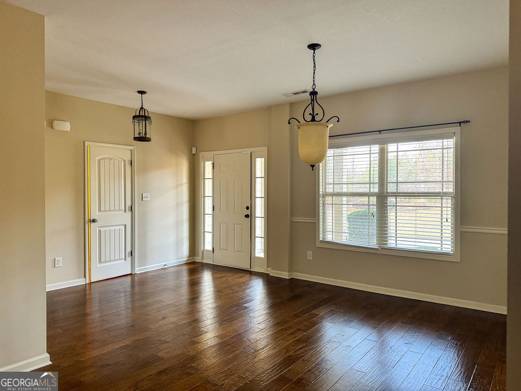 170 Fire Crk Trail Senoia, GA 30276 - Photo 6 of 62 a view of an empty room with wooden floor and a window