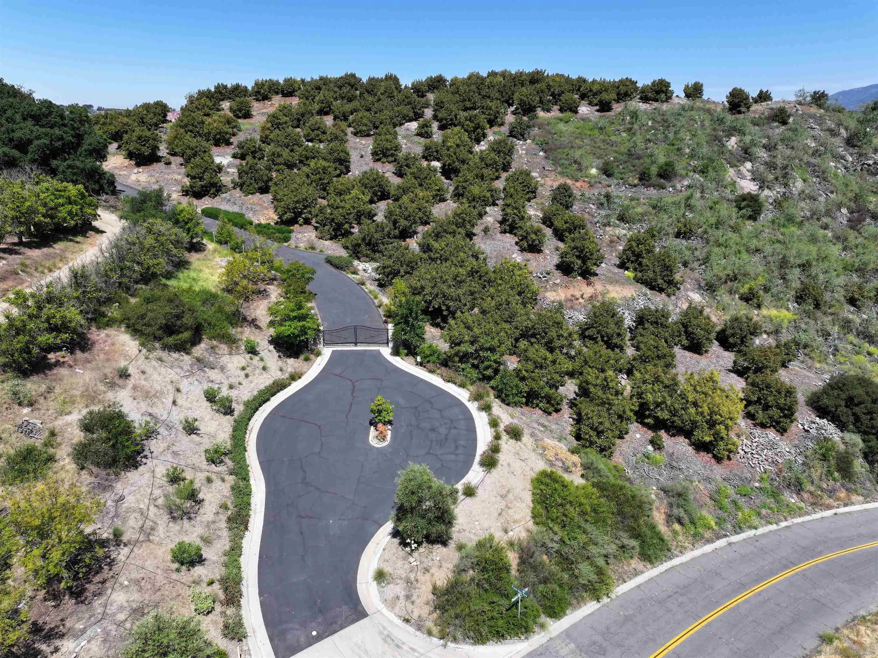 31752 Pauma Heights Road, Unit 3 Valley Center, CA 92061 - Photo 2 of 7 an aerial view of a house with a yard and lake view