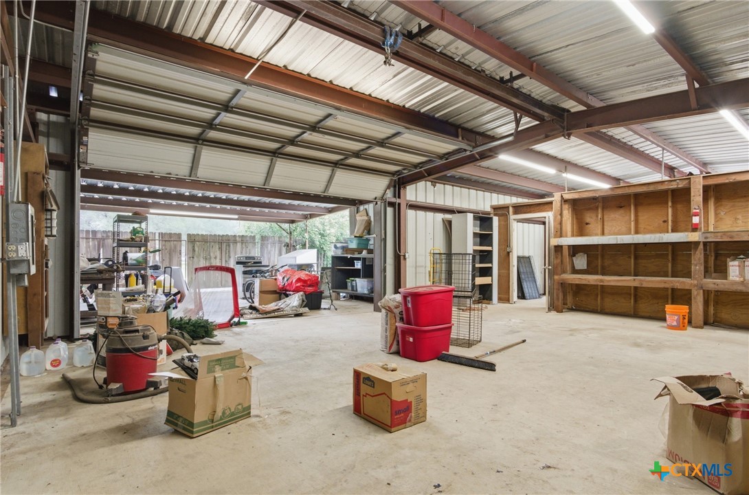 642 Phantom Rider Trail Spring Branch, TX 78070 - Photo 38 of 41 a view of a garage with couple of cars parked in it