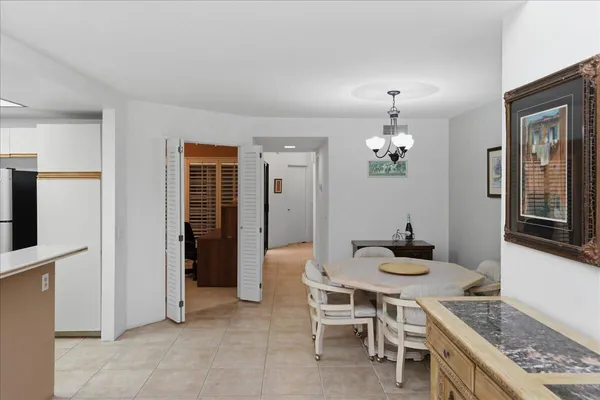 a kitchen with granite countertop a sink stove and refrigerator