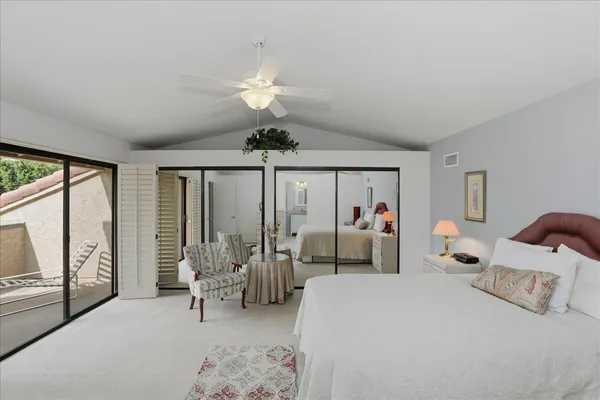 a bed room with bed and large windows