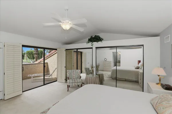 a bedroom with double bed and a chandelier
