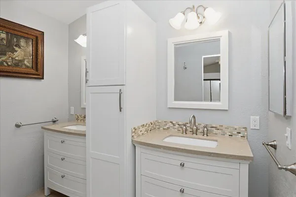 a bathroom with a sink vanity and a mirror