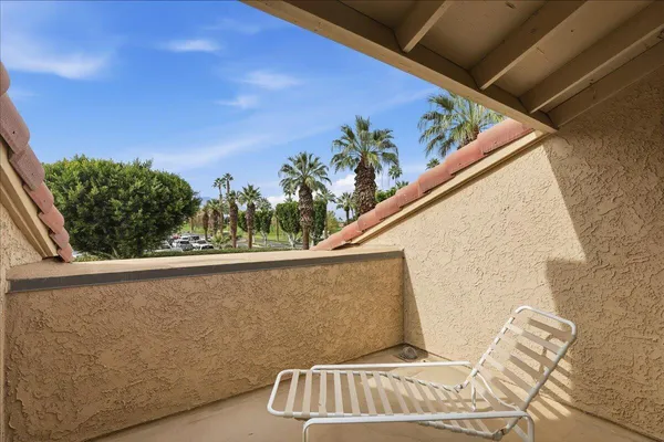 a view of balcony with furniture