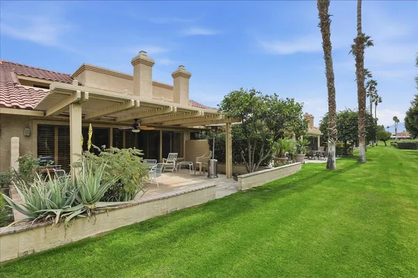 a front view of house with a garden and patio