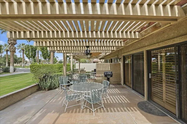 a patio with table and chairs