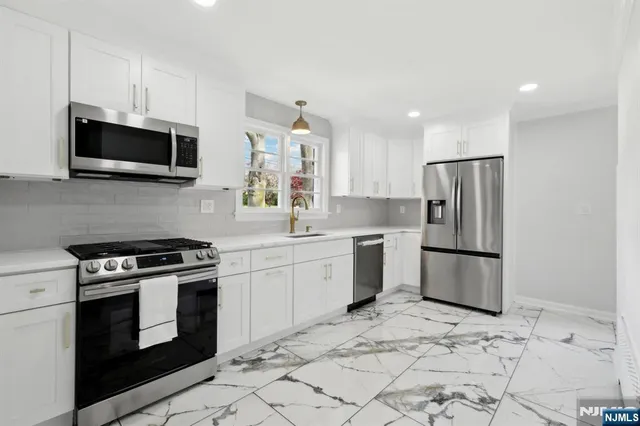 a kitchen with a stove a microwave and refrigerator