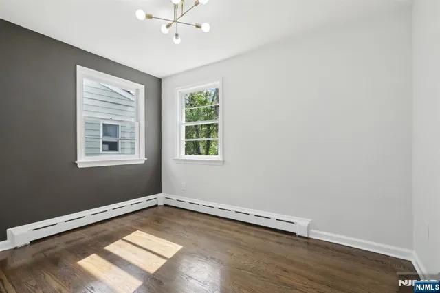 a view of a room with wooden floor and windows