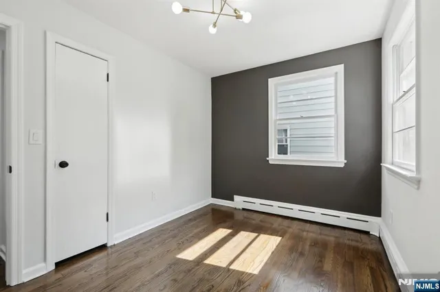 a view of a room with wooden floor and windows