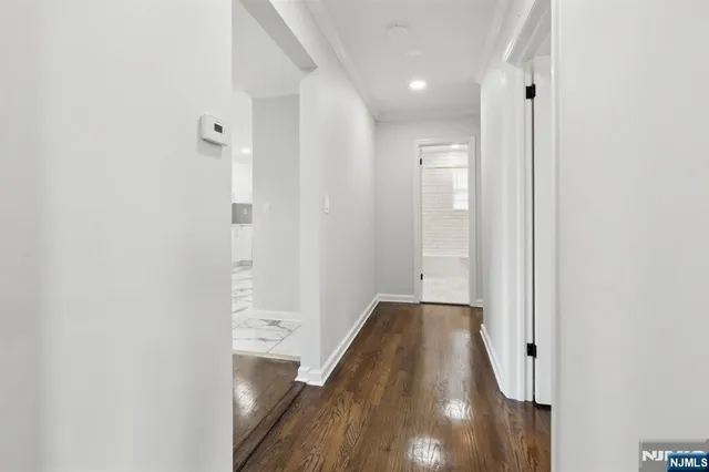 a view of hallway with wooden floor