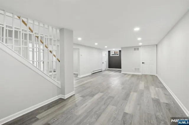 a view of an entryway with wooden floor