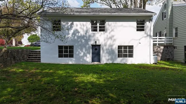 a view of house with backyard
