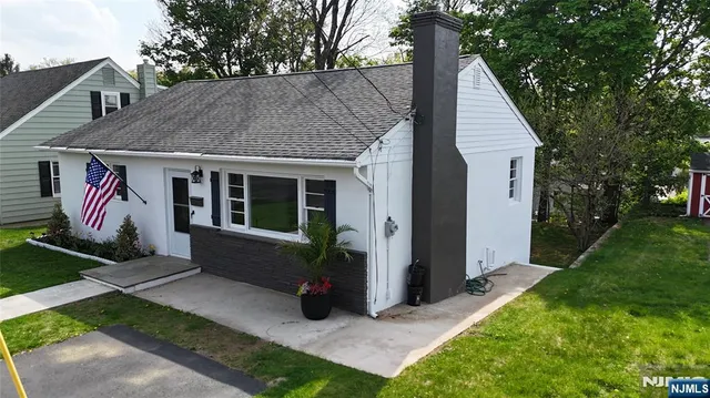a view of house with yard and outdoor seating