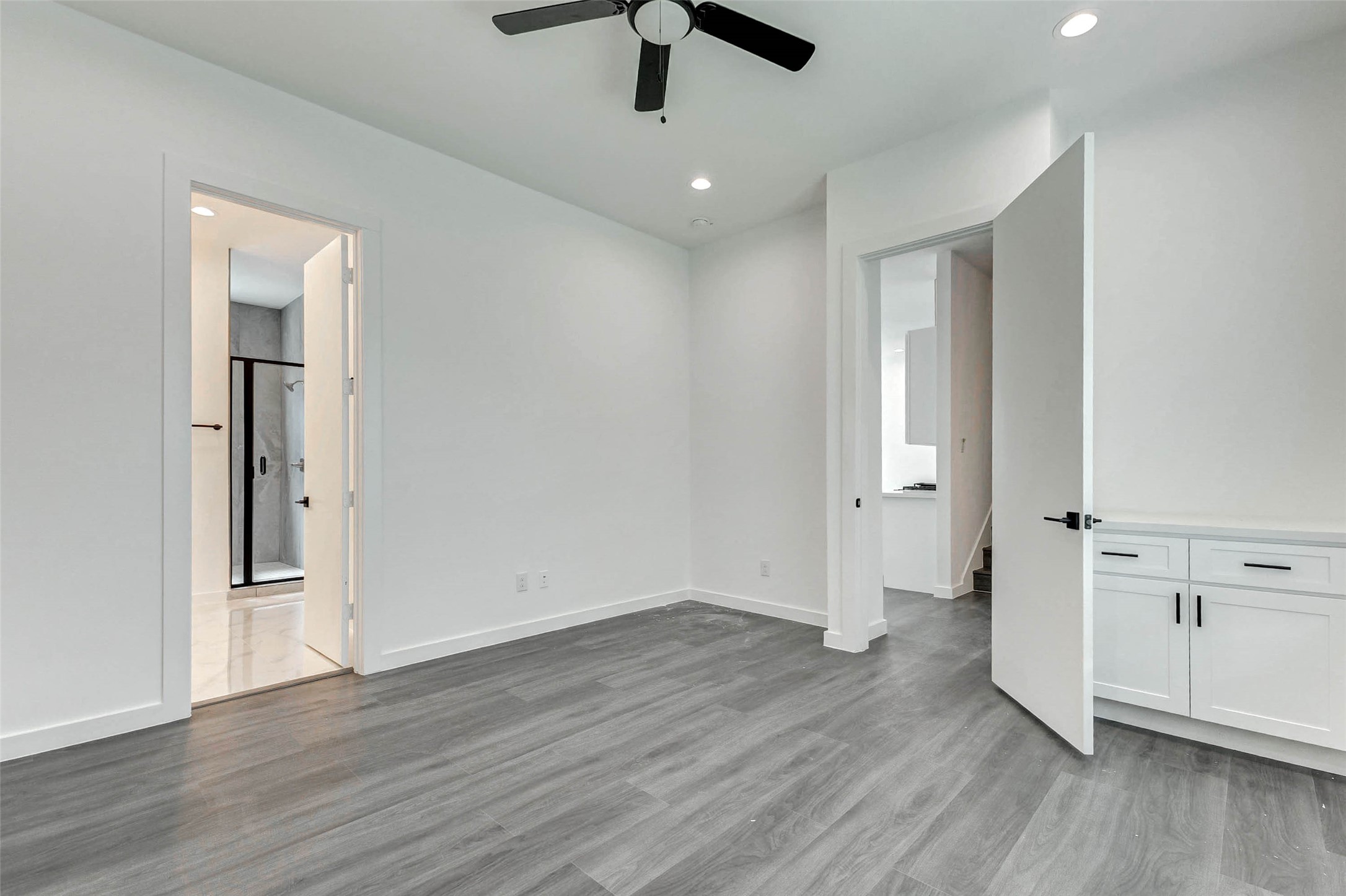 6017 Beall Street Houston, TX 77091 - Photo 15 of 33 This peaceful bedroom retreat offers privacy, cool tones, recessed lighting, and ensuite bath access. Bonus built-in cabinetry provides even more function in this elegant and thoughtfully designed space.