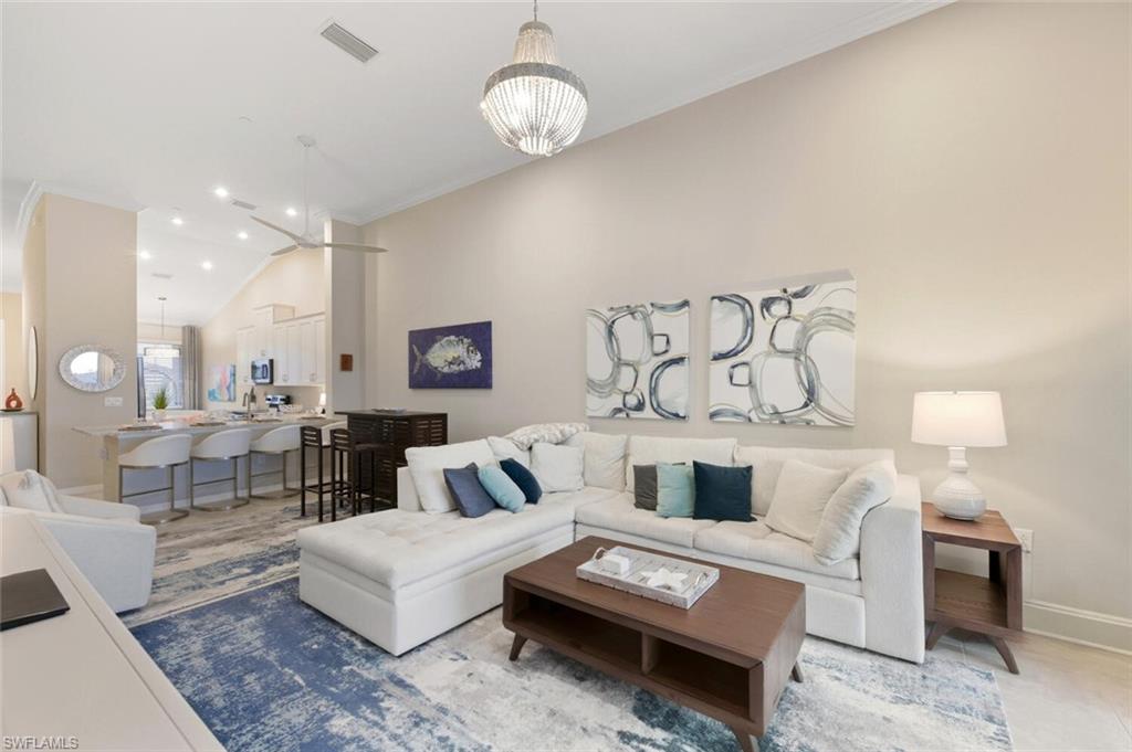 9365 Pocida Court, Unit 202 Naples, FL 34119 - Photo 14 of 40 a living room with furniture and a fireplace