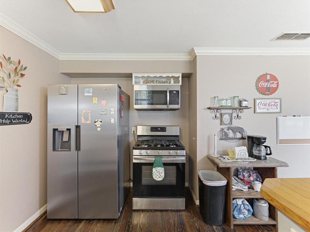 301 Ovilla Road Waxahachie, TX 75167 - Photo 20 of 38 a kitchen with stainless steel appliances a stove a refrigerator and a dining table