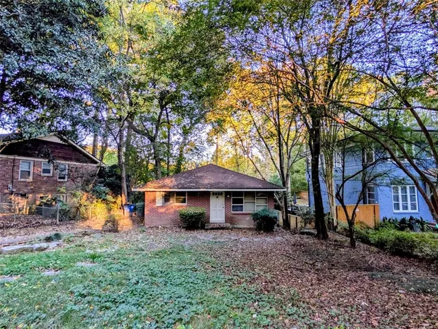 a view of a house with a yard and sitting area
