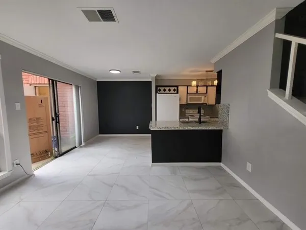 a view of kitchen with refrigerator and window