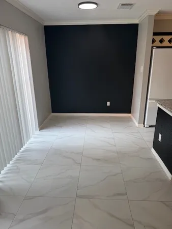 a view of an empty room and a window