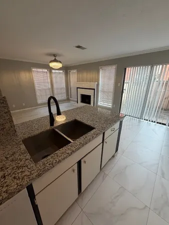 a kitchen with a stove a faucet and a sink